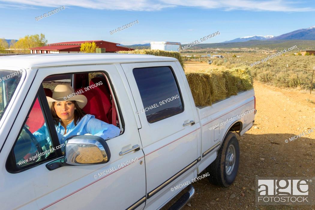 Stock Photo: Hispanic woman driving truck.