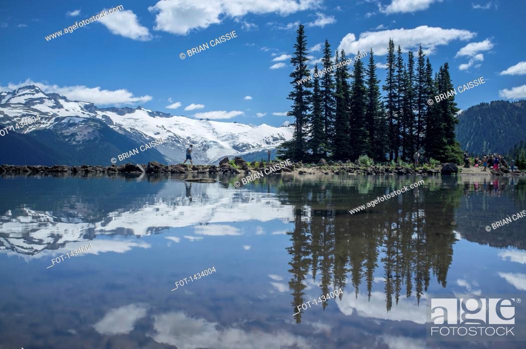 Stock Photo: Reflections of trees and snow covered mountain on Garibaldi Lake.