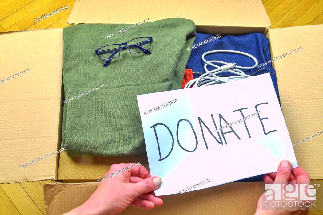 Stock Photo: Donation concepts with clothing and accesories in packing box. Giving and sharing with other people or recycling.