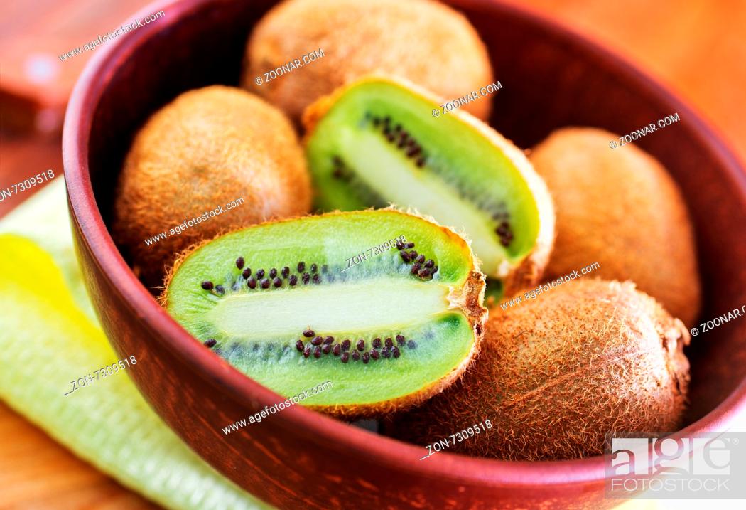 Stock Photo: kiwi in bowl and on a table.