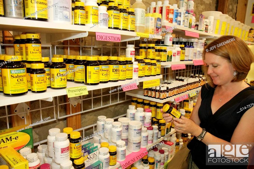 Stock Photo: Arkansas, Eureka Springs, Fain's Herbacy, Serious Supplements and Herbals, woman, shopping, shelves, display, alternative, botanical medicine, healing.