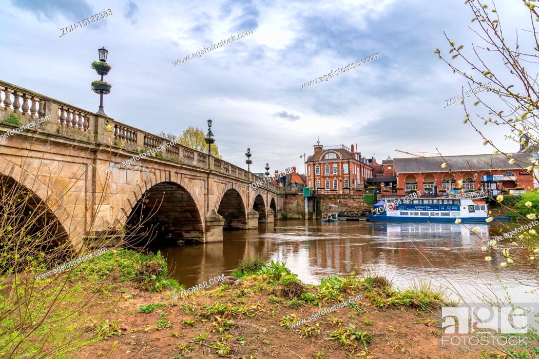 Stock Photo: Shrewsbury, Shropshire, England, UK - May 03, 2018: View at the River Severn and the Frankwell Suspension Bridge.