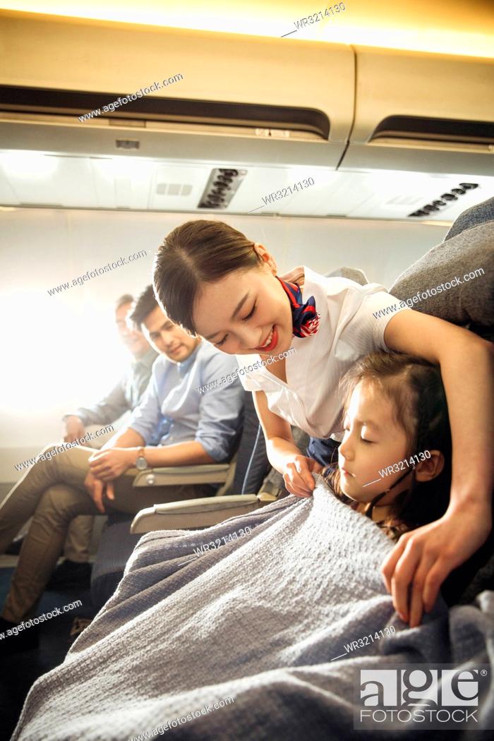 Stock Photo: Flight attendants and passengers on the plane.