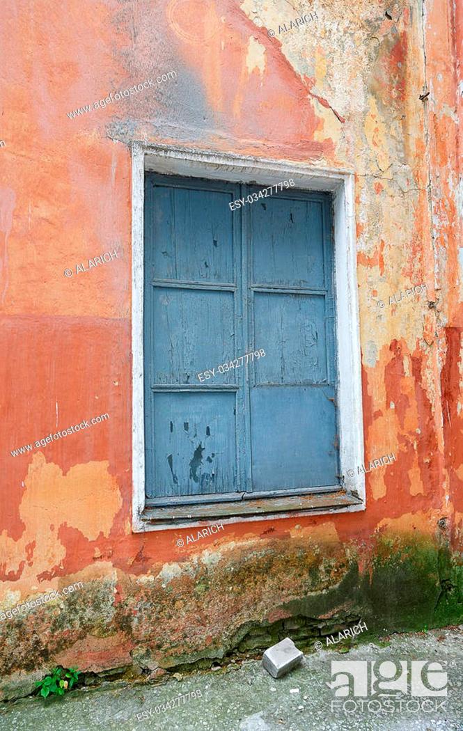 Stock Photo: boarded up window in an old building.