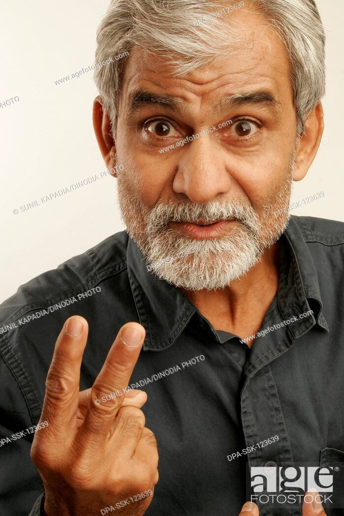 South Asian Indian old man late fifties with gray hair and beard wearing  dark blue shirt expressing..., Stock Photo, Picture And Rights Managed  Image. Pic. DPA-SSK-123639 | agefotostock