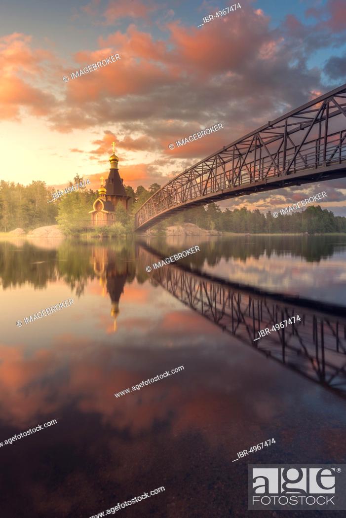 Stock Photo: Bridge and Church of St. Andrew at Vuoksi River during sunset, Vasilyevo, Leningrad region, Russia, Europe.