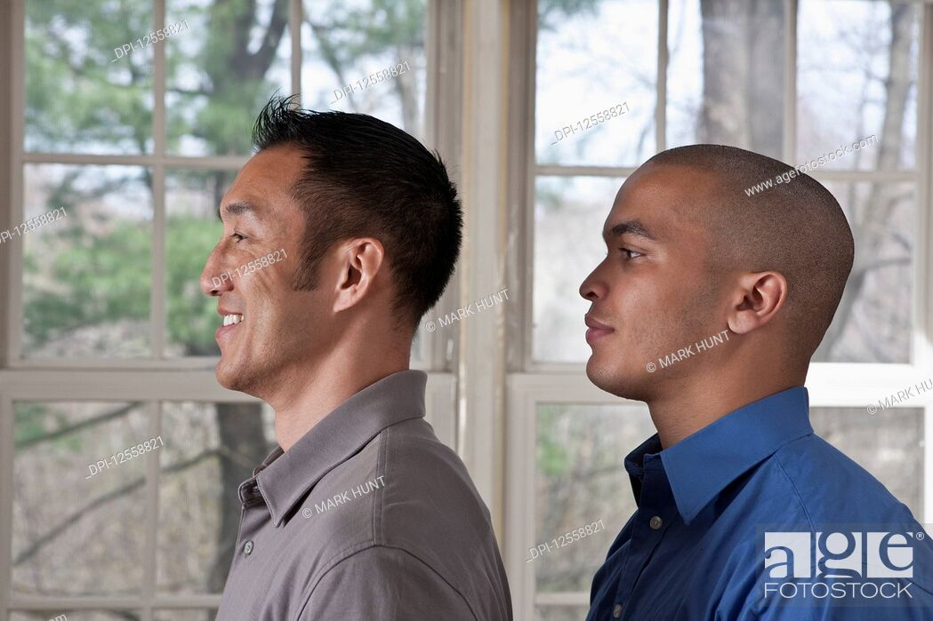 Stock Photo: Portrait of the side view of two young businessmen standing facing left.