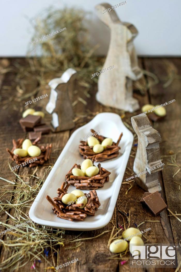 Stock Photo: No People, Indoors, Interior, Celebration, Inside, Backgrounds, Wooden, Sugar, Sweet, Nutrition, Photo, Figure, Easter, Hay, Egg, Rustic, Nest, Chocolate, Candy, Shot, Occasion, Bunny, Confectionery, Choc, Chocó, Easter Candy, Selective Focus, Studio Shot, Food And Drink, Easter Bunny