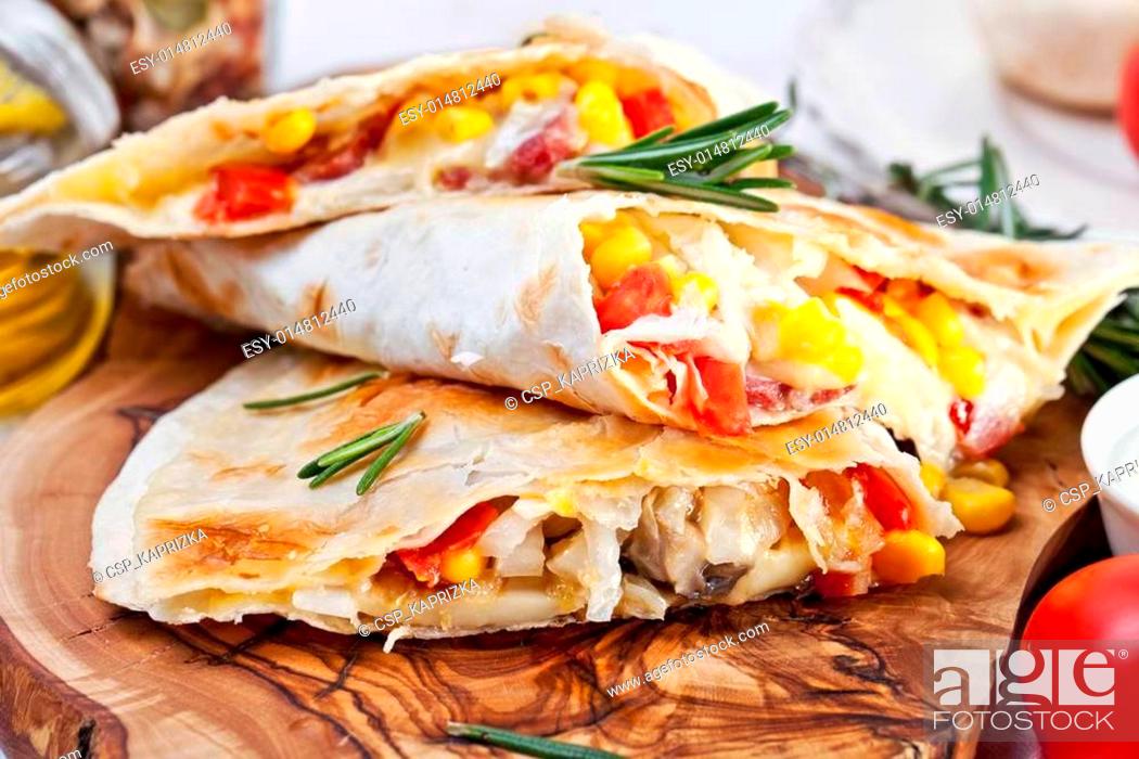 Stock Photo: Mexican tortilla with meat stuffing, corn and vegetable salsa.