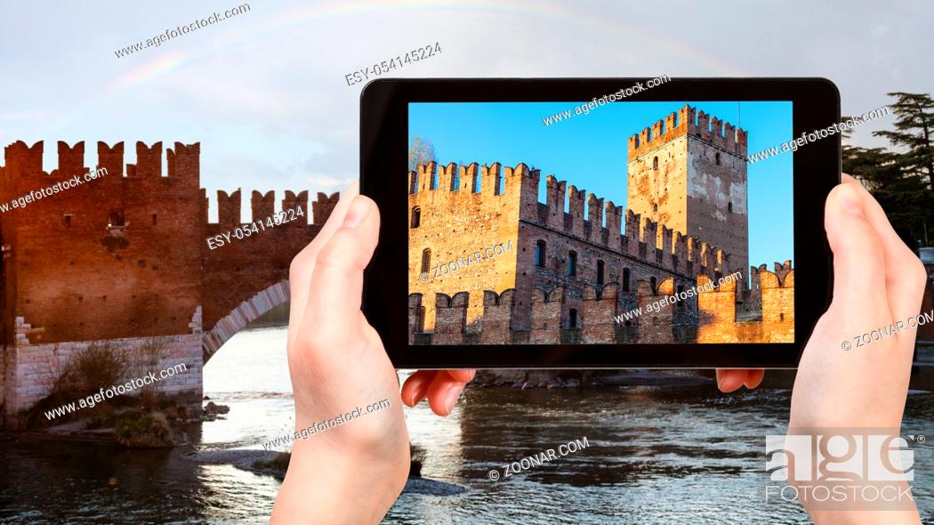 Stock Photo: travel concept - tourist photographs Castelvecchio (Scaliger) Castel in Verona city in Italy in spring evening on tablet.