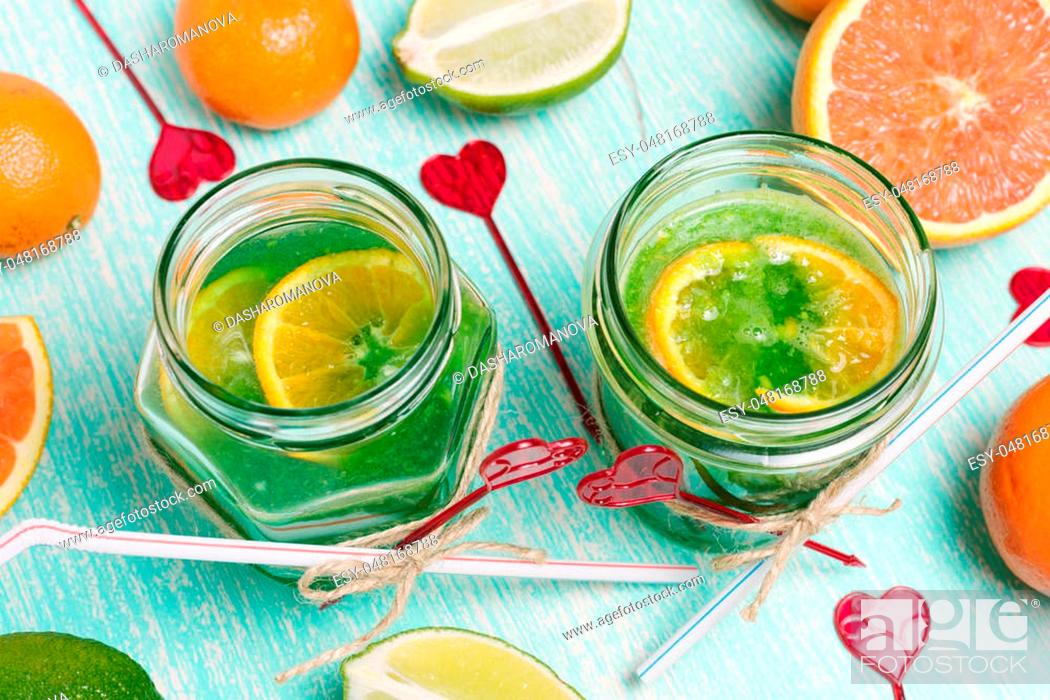 Stock Photo: Two jar glasses of homemade lemonade on wooden table, with Love Valentine's hearts.