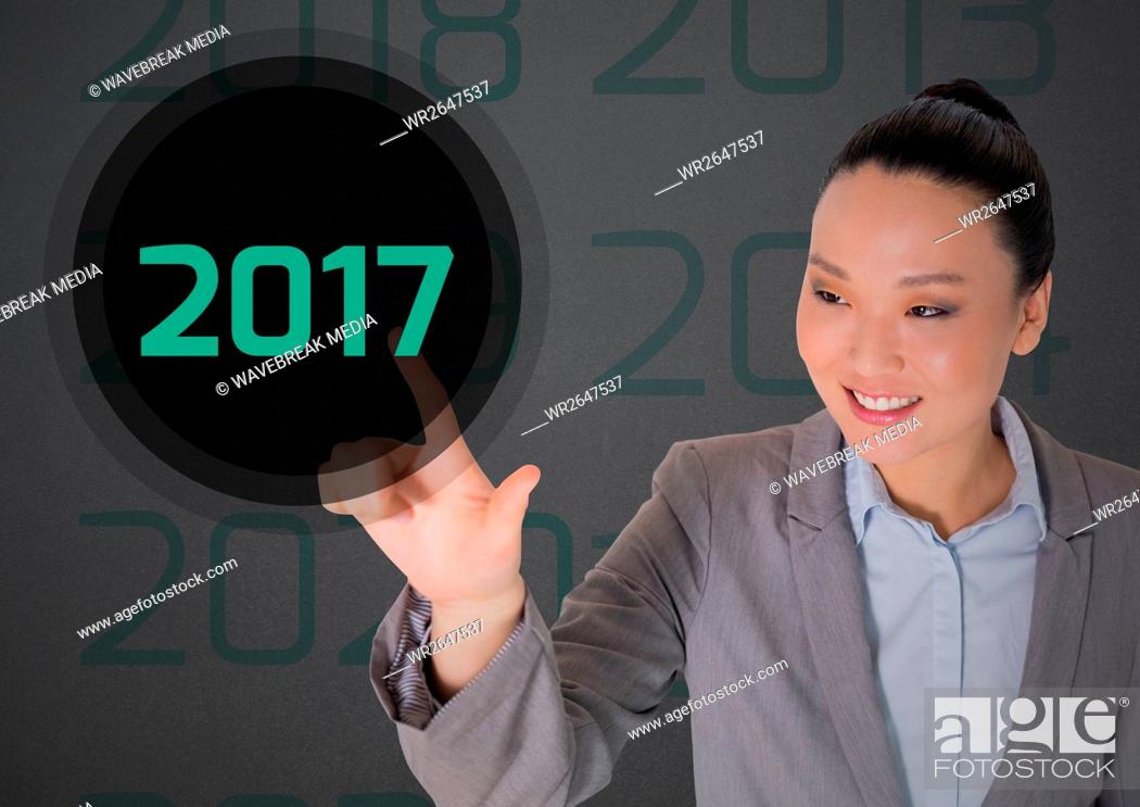 Stock Photo: Business woman in digitally generated background touching 2017.