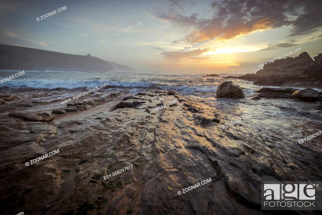 Stock Photo: Sunset in Tagle beach. panoramic view of nice colorful huge cliff and sea on the back. Cantabria. Spain.