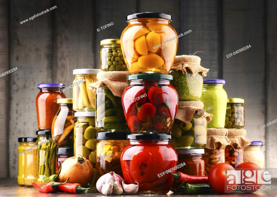 Stock Photo: Jars with variety of pickled vegetables. Preserved food.