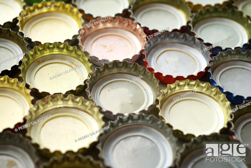 Stock Photo: Collection of bottle caps on a stone table.
