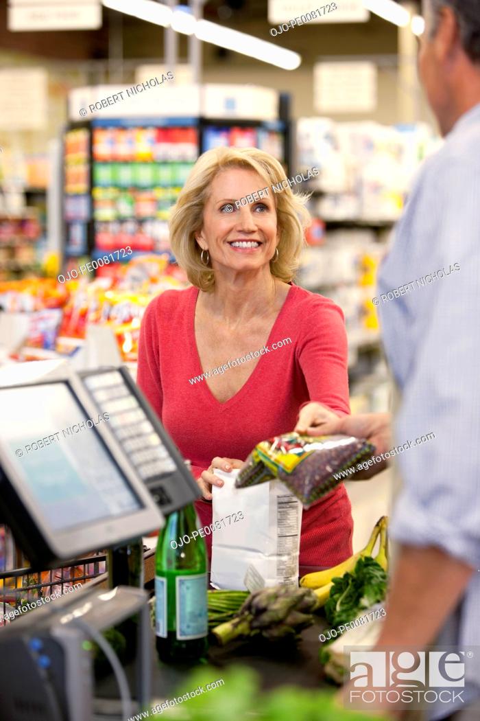 Stock Photo: Woman buying groceries at supermarket.