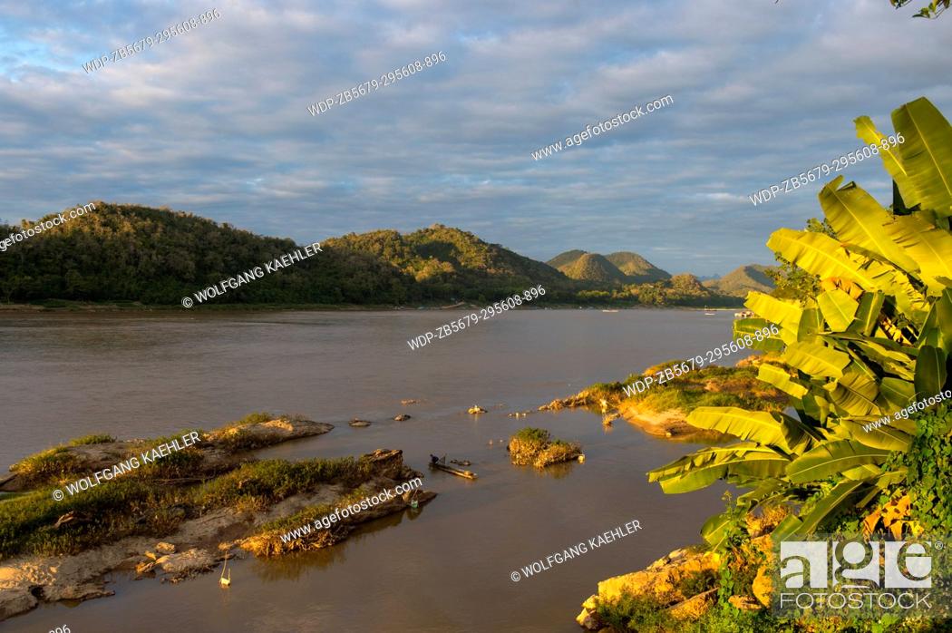 Stock Photo: The Mekong River in evening light at sunset near the UNESCO world heritage town of Luang Prabang in Central Laos.