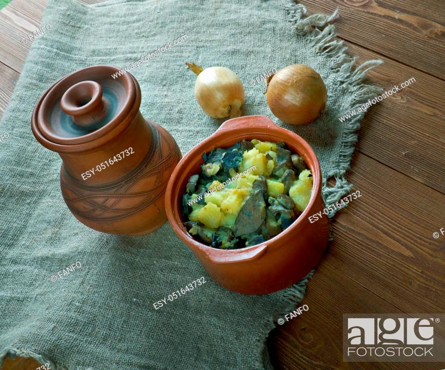 Stock Photo: Mushroom Tushanka- Belarusian potato stew on a wooden background.