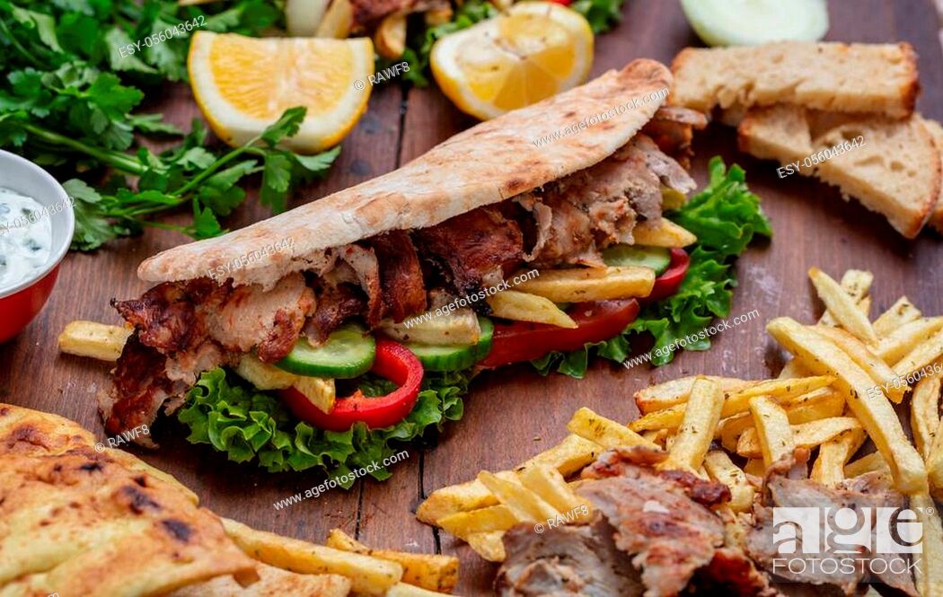Stock Photo: Gyros, shawarma, take away, street food. Sandwich with meat on wooden table, closeup view.