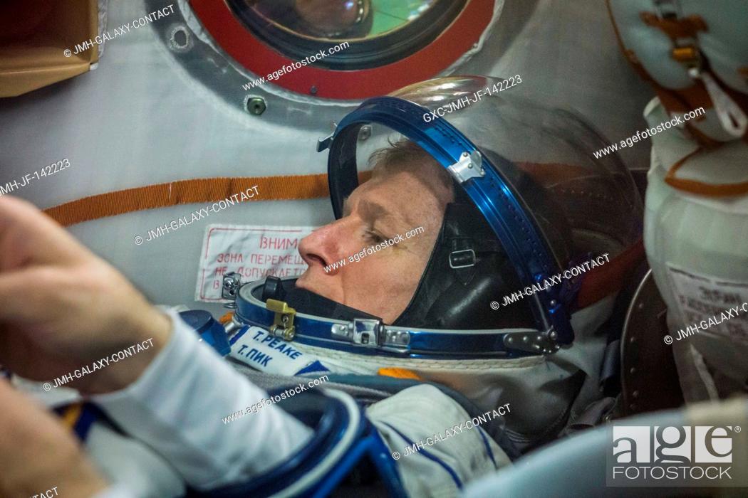 Stock Photo: In the Integration Facility at the Baikonur Cosmodrome in Kazakhstan, Expedition 46-47 crewmember Tim Kopra of NASA flashes a smile as he conducts a pressure.