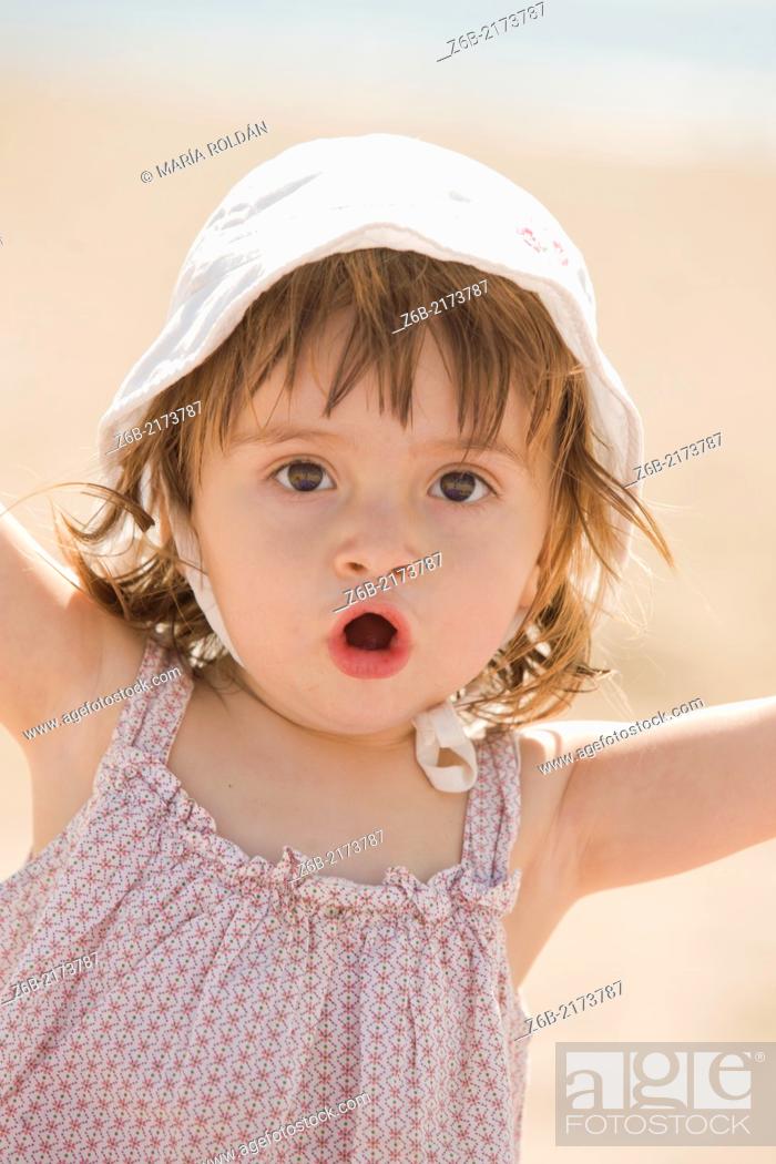 Stock Photo: Baby girl, 18/19 months, Outdoors, Sunny, Beach, Mediterranean sea, Valencia, Spain, vacation, Hat.