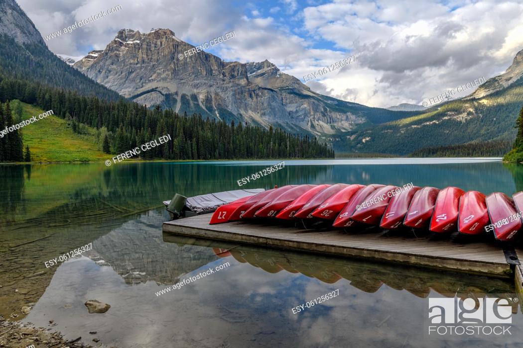 Stock Photo: Reflecting red kayaks on deck at the Emerald Lake in Yoho National Park, British Columbia, Canada.
