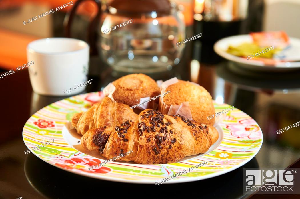 Stock Photo: Plate with chocolate croissants and muffins for breakfast.