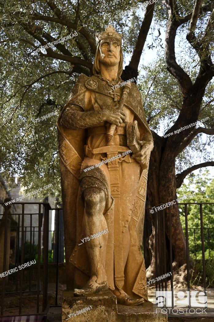 Stock Photo: Statue of King Alfonso X or Fernando III nest to the Tower of the Lions, Alcazar of Cordoba, Spain.