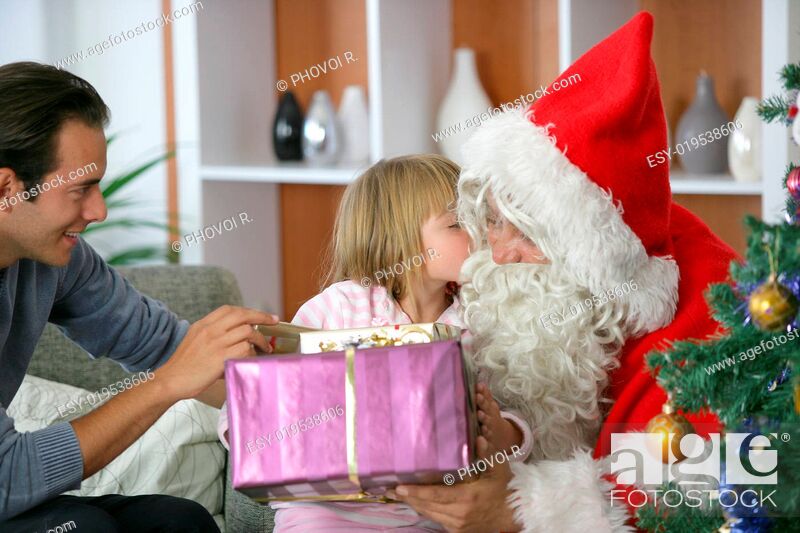 Stock Photo: Girl kissing on the cheek Father Christmas with gifts in their hands.