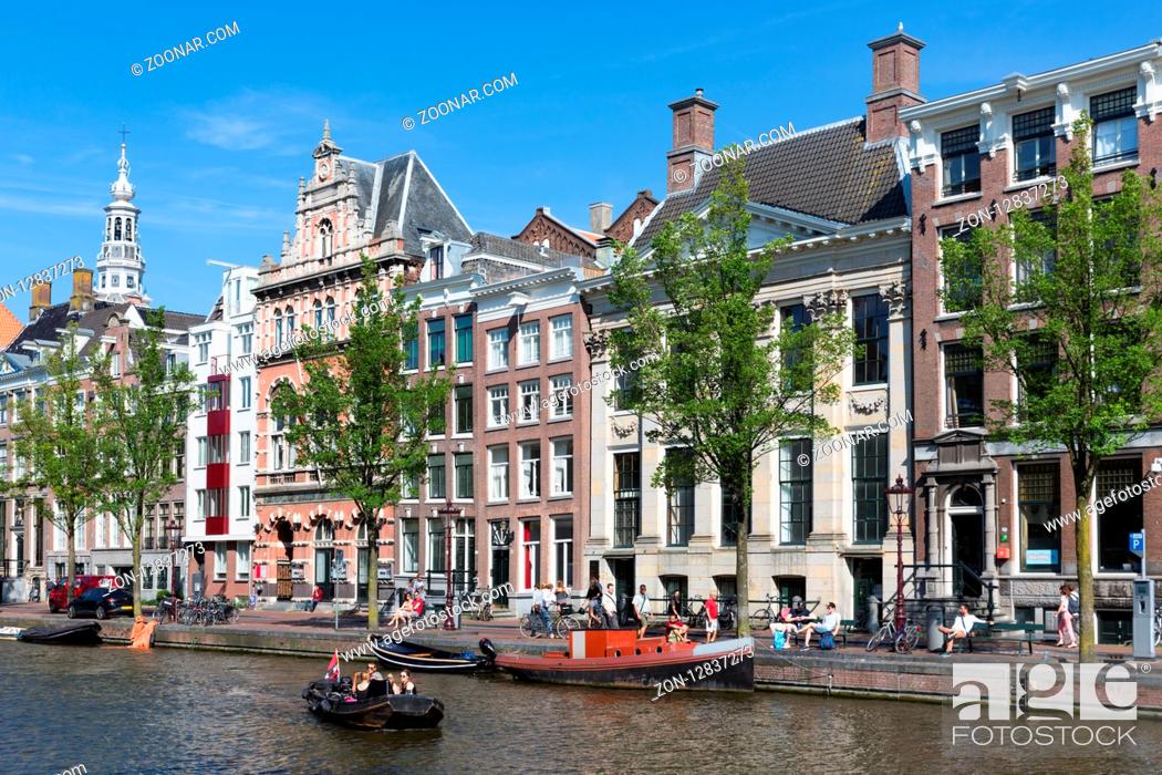 Stock Photo: AMSTERDAM, THE NETHERLANDS - AUG 06: Small boats in canal with historic mansions on August 06, 2015 in Amsterdam, the Netherlands.