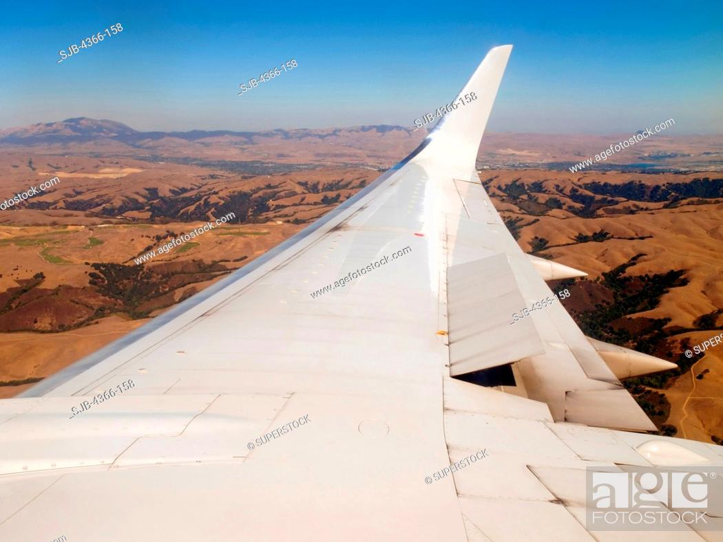 Stock Photo: Boeing 737 Wing Flying Over California.