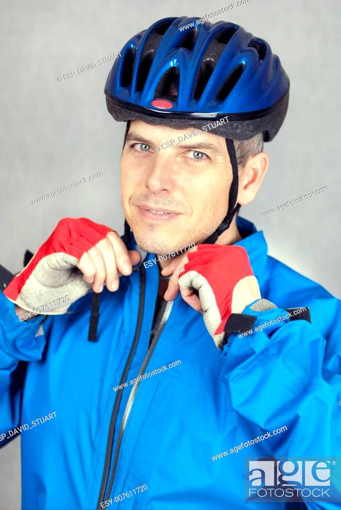 Stock Photo: Cyclist Puts On his Helmet 2.