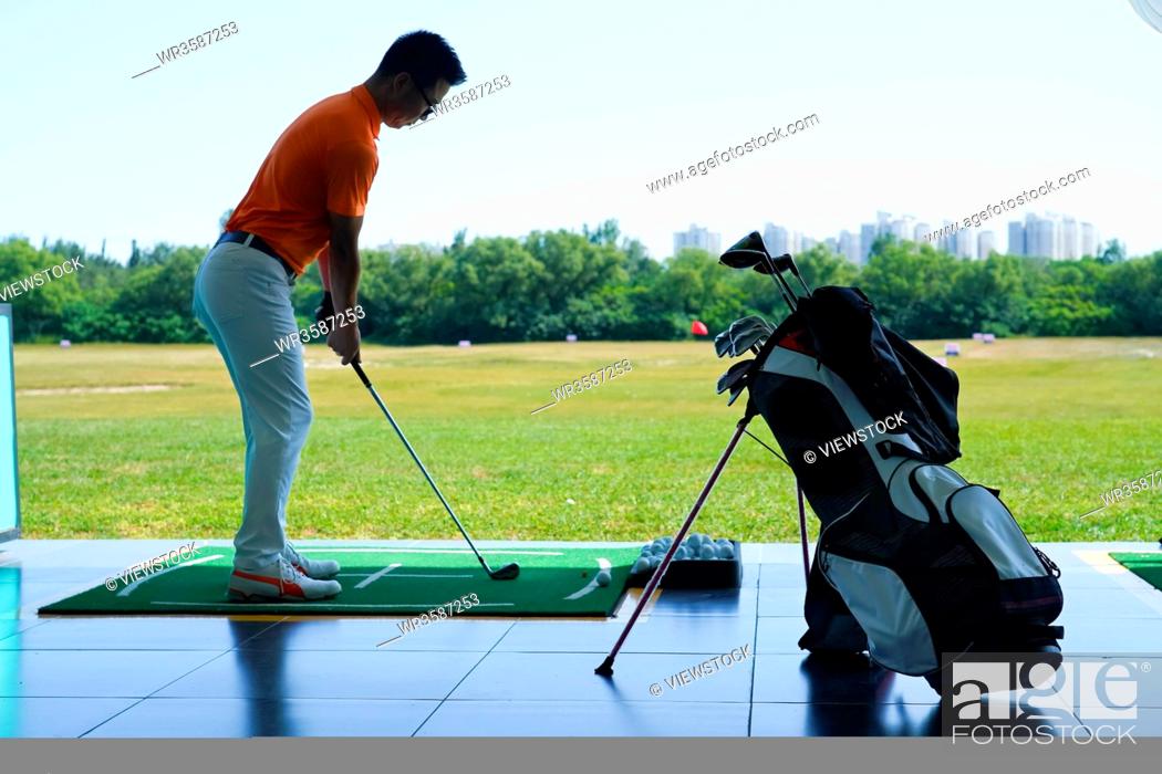 Stock Photo: Young men playing golf.