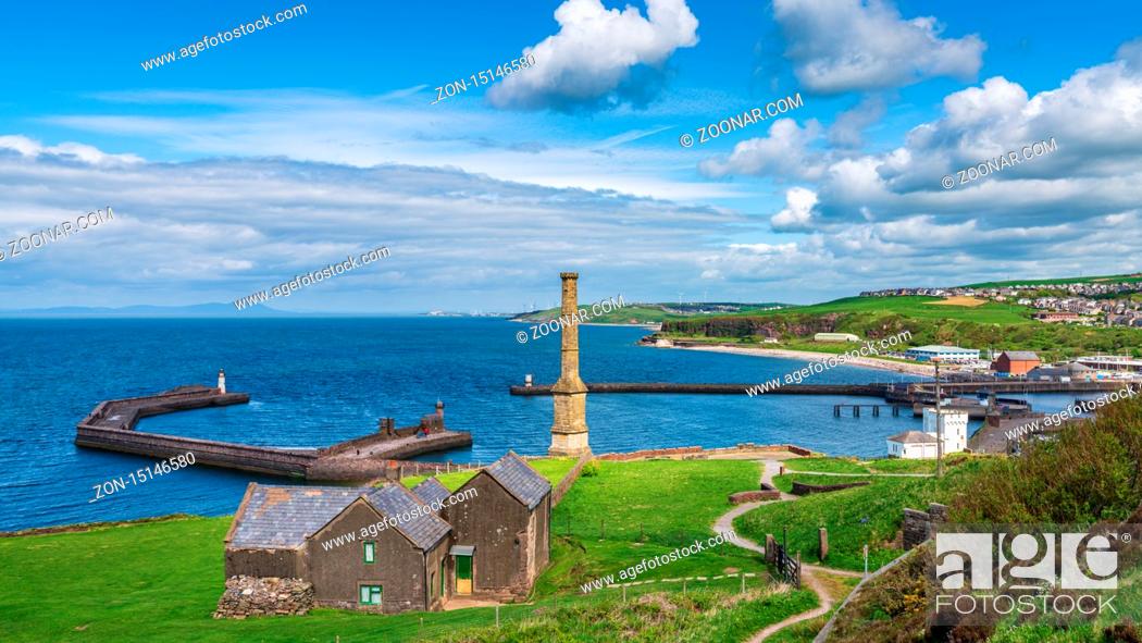 Stock Photo: Whitehaven, Cumbria, England, UK - May 03, 2019: View over Whitehaven, the Candlestick Chimney, the piers, the lighthouses and Bransty in the background.