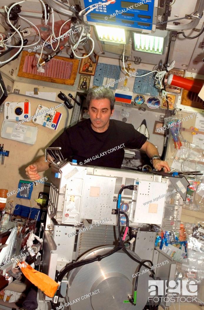 Stock Photo: European Space Agency (ESA) astronaut Leopold Eyharts, Expedition 16 flight engineer, works with the Treadmill Vibration Isolation System (TVIS) removed from.
