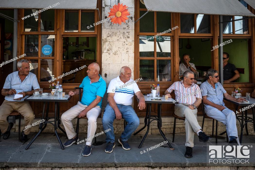 Stock Photo: Gjirokaster, Albania Men drinking morning coffee in a cafe.