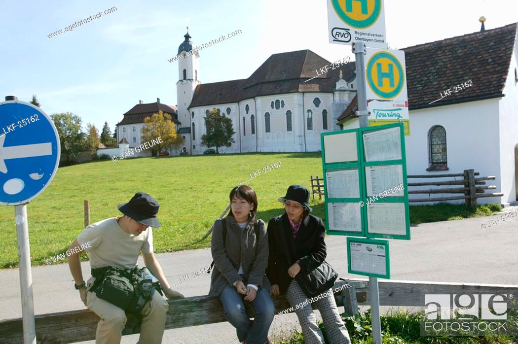 Stock Photo: Japanese tourists at the bus stop near Wieskirche, Steingaden, Bavaria, Germany.