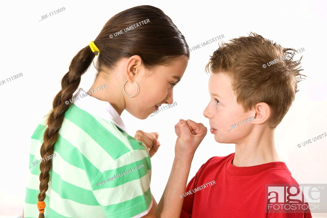 Stock Photo: Small boy and a bigger girl threatening each other with their fists.