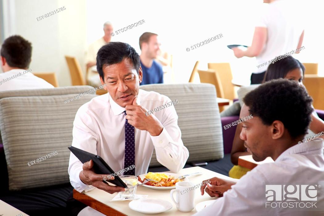 Stock Photo: Businessmen Meeting Over Breakfast In Hotel Restaurant.
