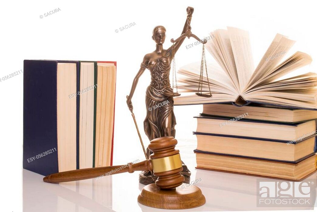 Stock Photo: statue of justice, judge's hammer behind books on a white background.