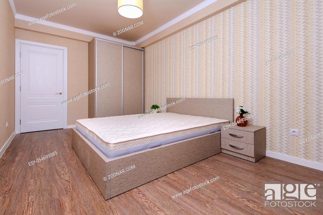 Stock Photo: Brand new almost empty brown bedroom with bare mattress at twin bed and bedside tables.