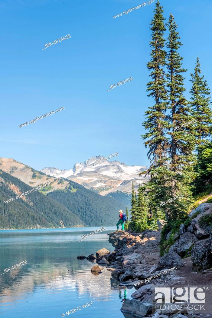 Stock Photo: Hiker at Garibaldi Lake, turquoise mountain lake, reflection of a mountain range, Guard Mountain and Deception Peak, glacier, Garibaldi Provincial Park.