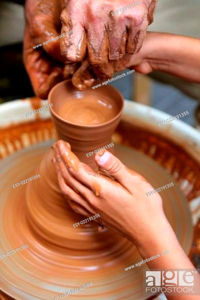 Stock Photo: craftsman potter hands of teacher and pupil clay pottery.
