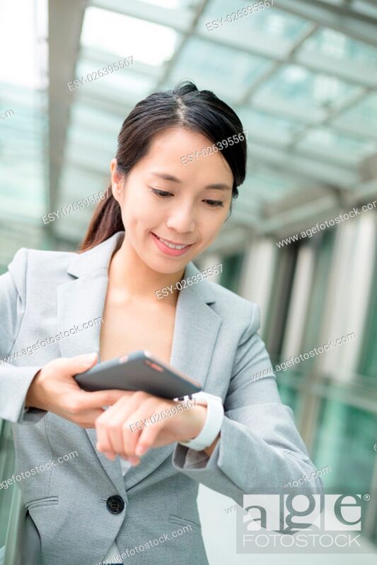 Stock Photo: Business woman use of smart phone and watch.