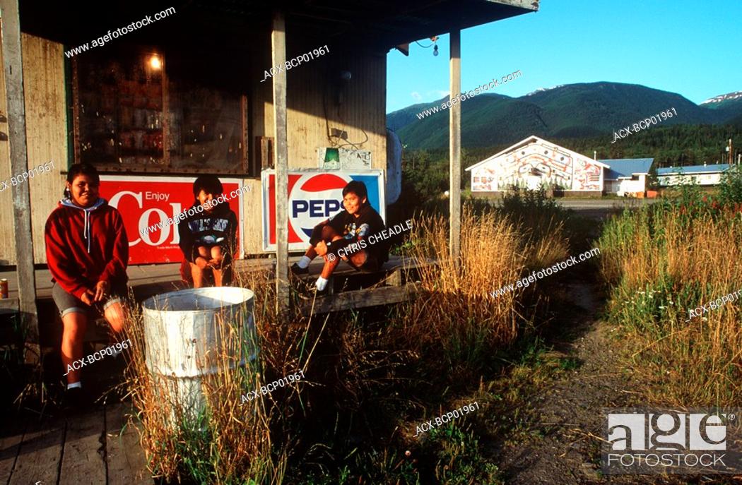 Stock Photo: Nass River Valley, school girls on storefront porch in New Aiyanch, British Columbia, Canada.