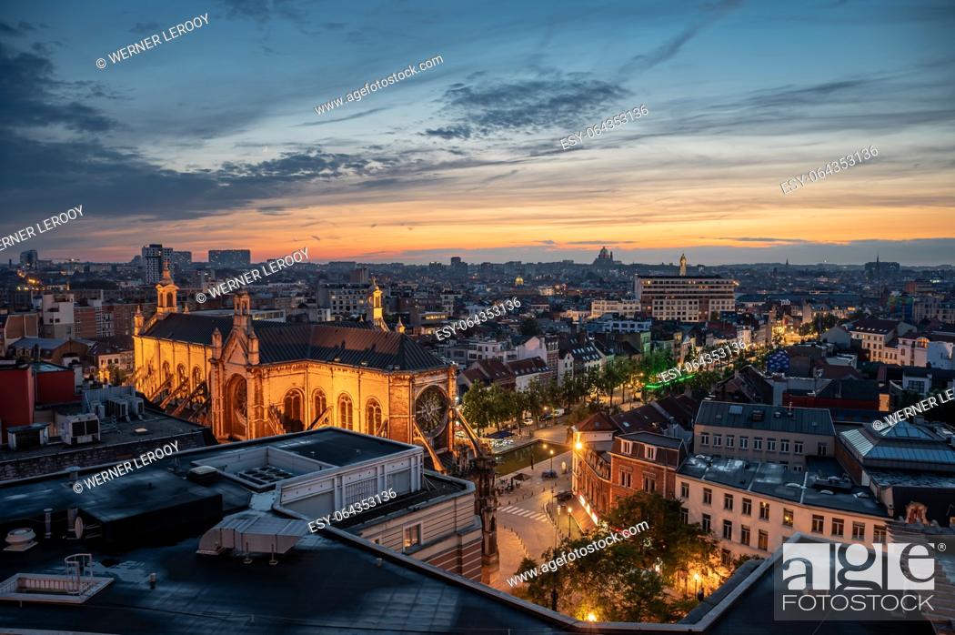Stock Photo: Brussels city center, Belgium, July 20 , 2023 - Colorful sunset over old town with the Saint Catherine church and rooftops.