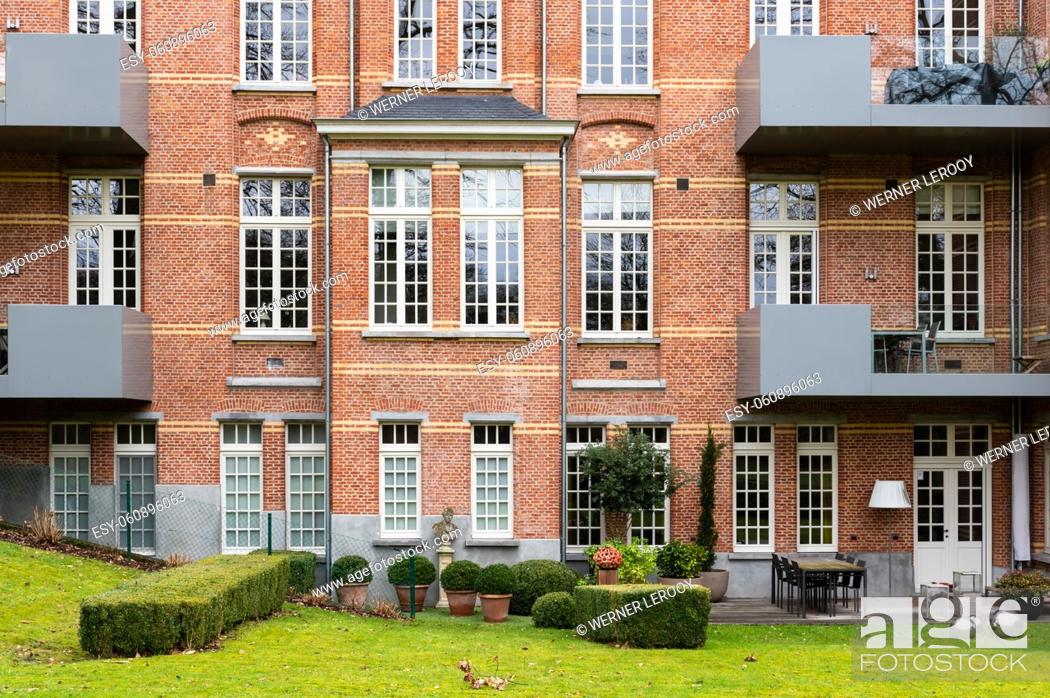 Stock Photo: Leuven, Flemish Brabant Region, Belgium - 01 29 2022: Renovated facade of brick stone apartment block.
