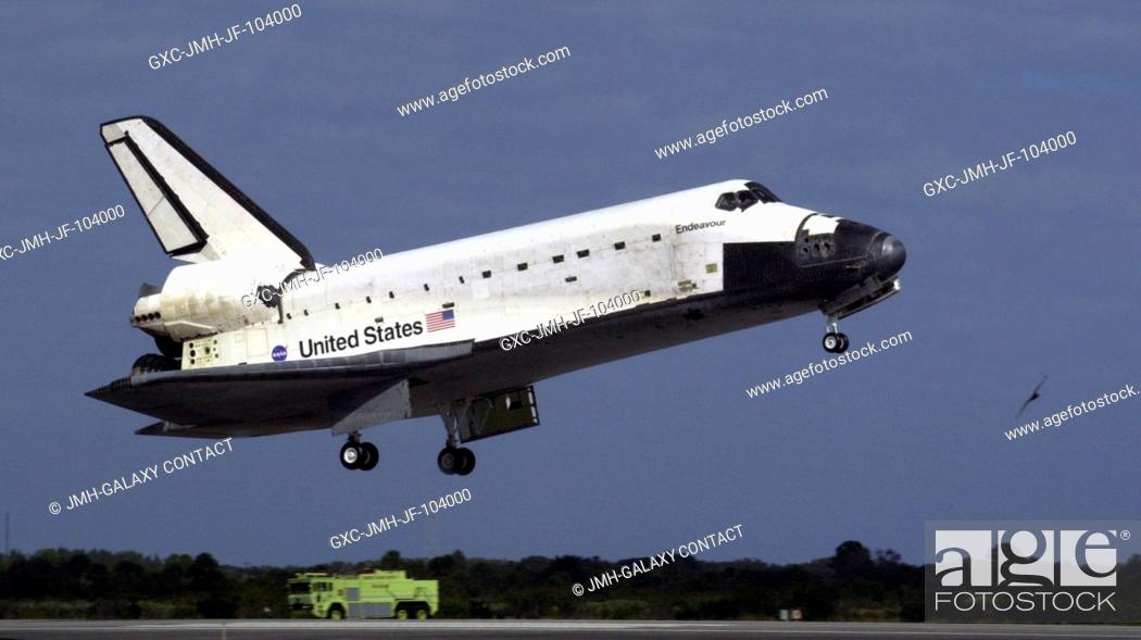 Stock Photo: The Space Shuttle Endeavour's main landing gear is just about to touch down on Runway 15 at the Shuttle Landing Facility at the Kennedy Space Center (KSC).