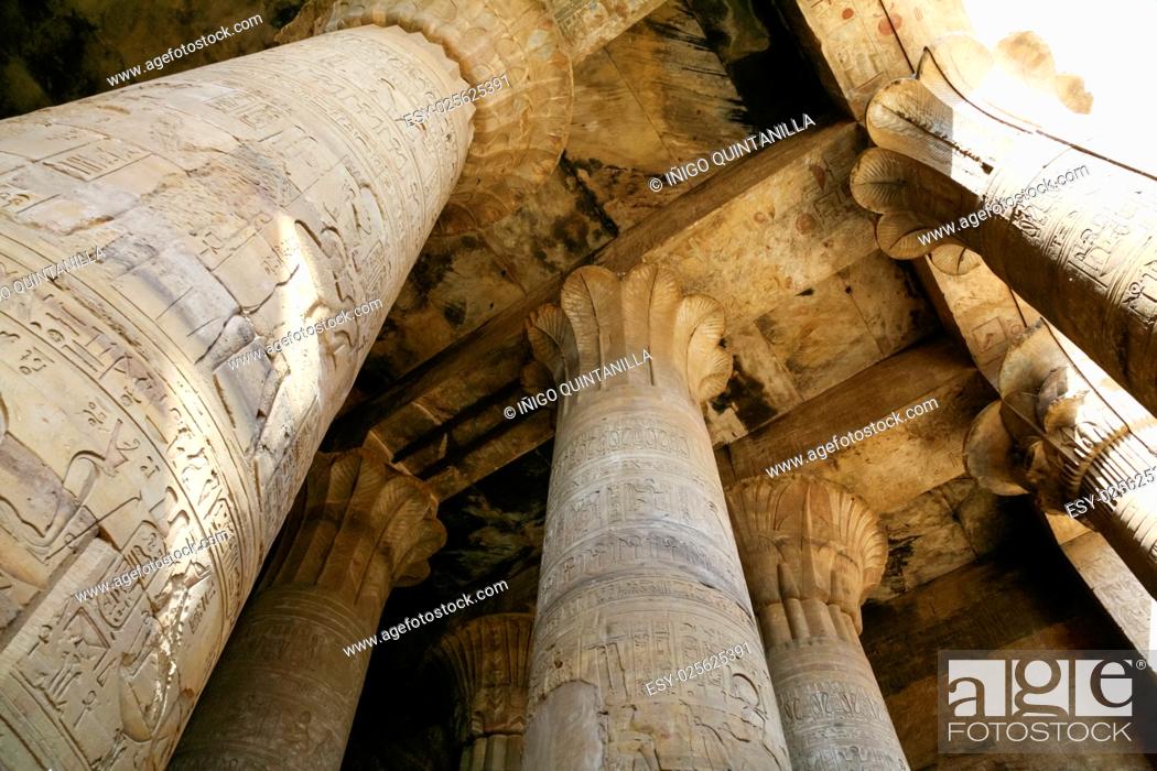 Stock Photo: big stone columns in Egyptian Edfu Temple of falcon god Horus, with carving figures and hieroglyphs, in Egypt, Africa.