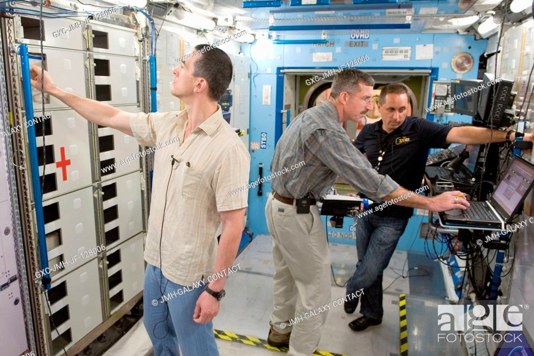 Stock Photo: NASA astronaut Dan Burbank (center), Expedition 29 flight engineer and Expedition 30 commander; along with Russian cosmonauts Anatoly Ivanishin and Anton.